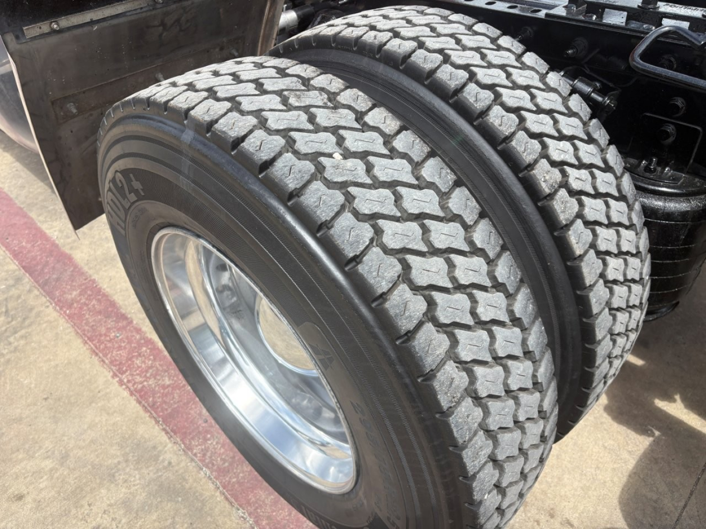 Dual rear tires and wheel assembly of a 2022 International LT truck showing tread pattern and hub, part of the drive axle.