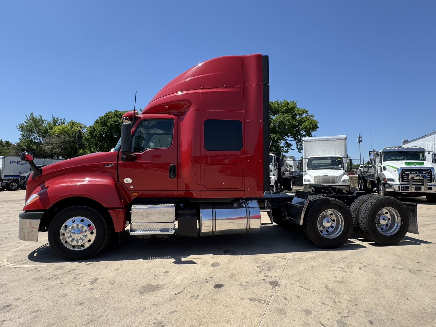 2022 International LT truck side profile showing sleeper cab, fuel tanks, and dual rear axles.