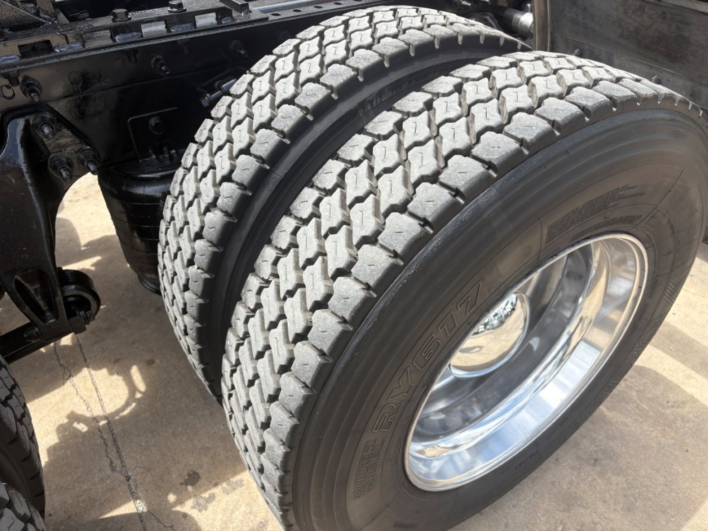 Rear dual tires on a 2022 International LT truck chassis showing aggressive tread pattern and chrome wheel rims.