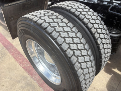 Dual rear tires and wheel assembly of a 2022 International LT truck showing tread pattern and hub, part of the drive axle.