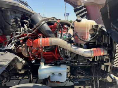 Engine bay of a 2022 International LT with visible hoses, coolant reservoir, and various components. No legible label text discernible.