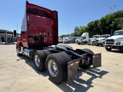 International LT truck tractor chassis in a parking lot rear view showing dual rear tires and fenders.
