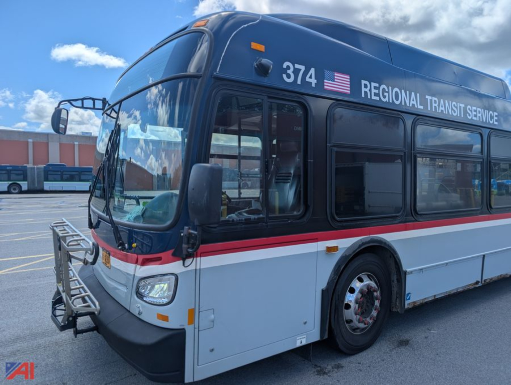 Bus front-left view of a 2013 New Flyer XD60 transit bus showing Regional Transit Service branding, number 374, and safety mirrors.
