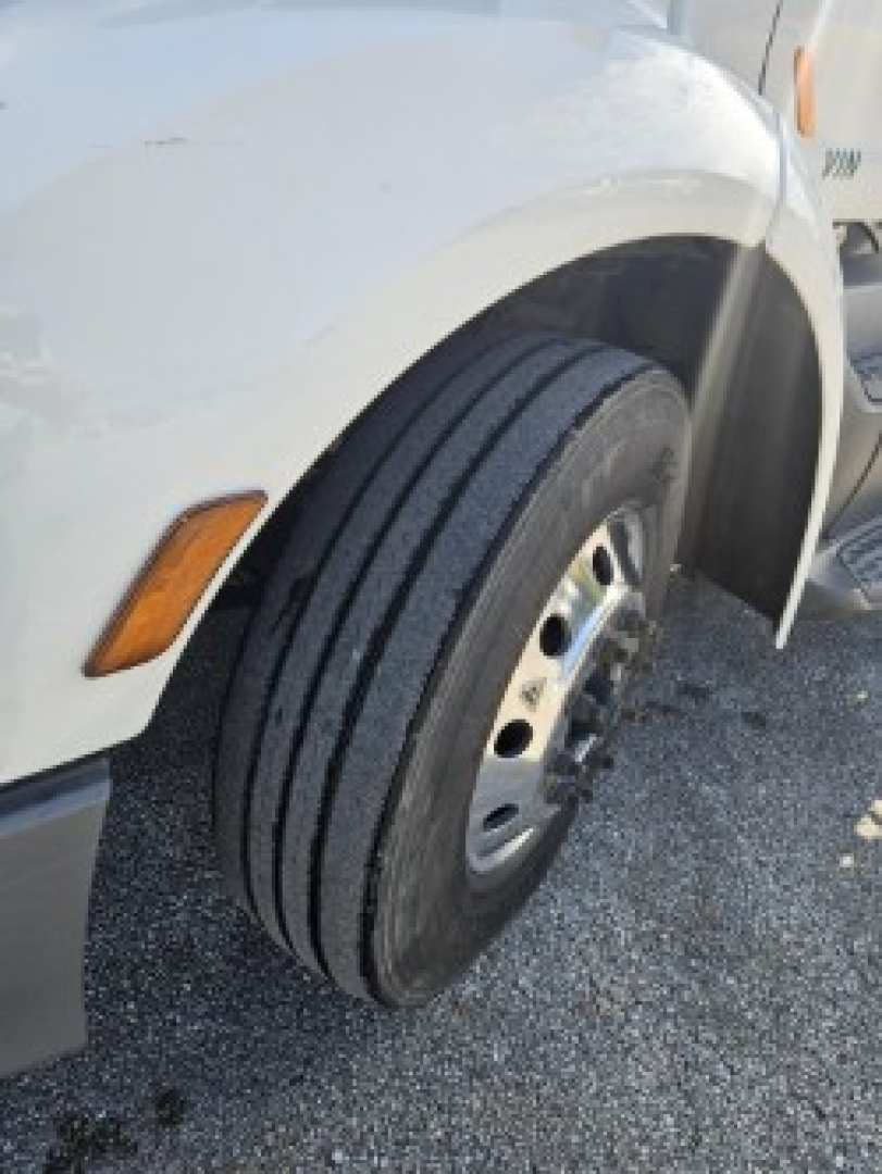 Peterbilt 579 front wheel and fender close-up showing front tire tread and wheel rim