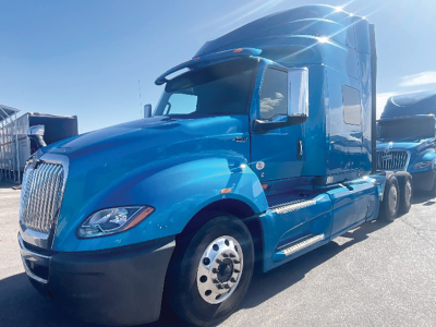 Blue International LT series tractor-trailer cab showing front grille, headlights, and side steps.