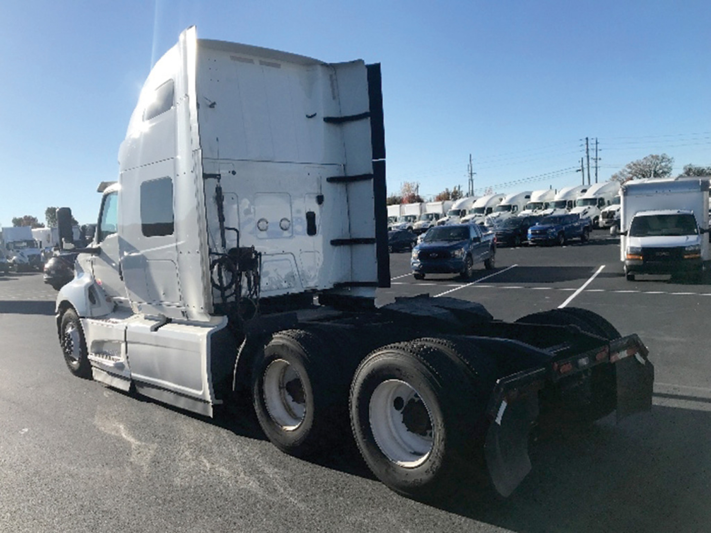 Truck cab and chassis of a 2022 International LT625 tractor from a side rear angle showing the sleeper cab and rear wheels