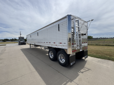 Stoughton 42' aluminum grain hopper trailer with corrugated sidewalls and dual rear axles, rear access ladder, and tail area, side profile view.