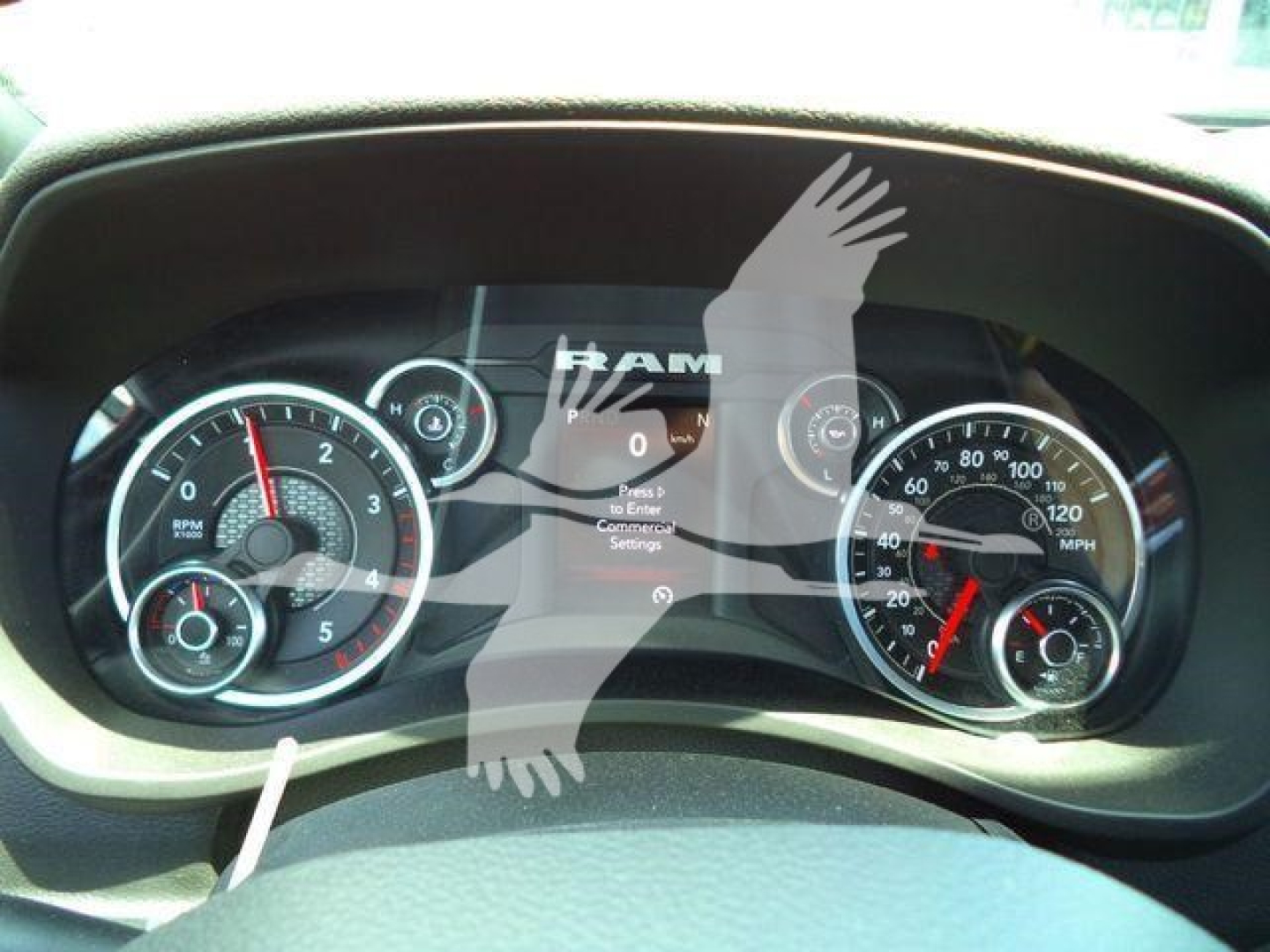 Ram dashboard showing instrument cluster with loading screen and RAM logo overlay.
