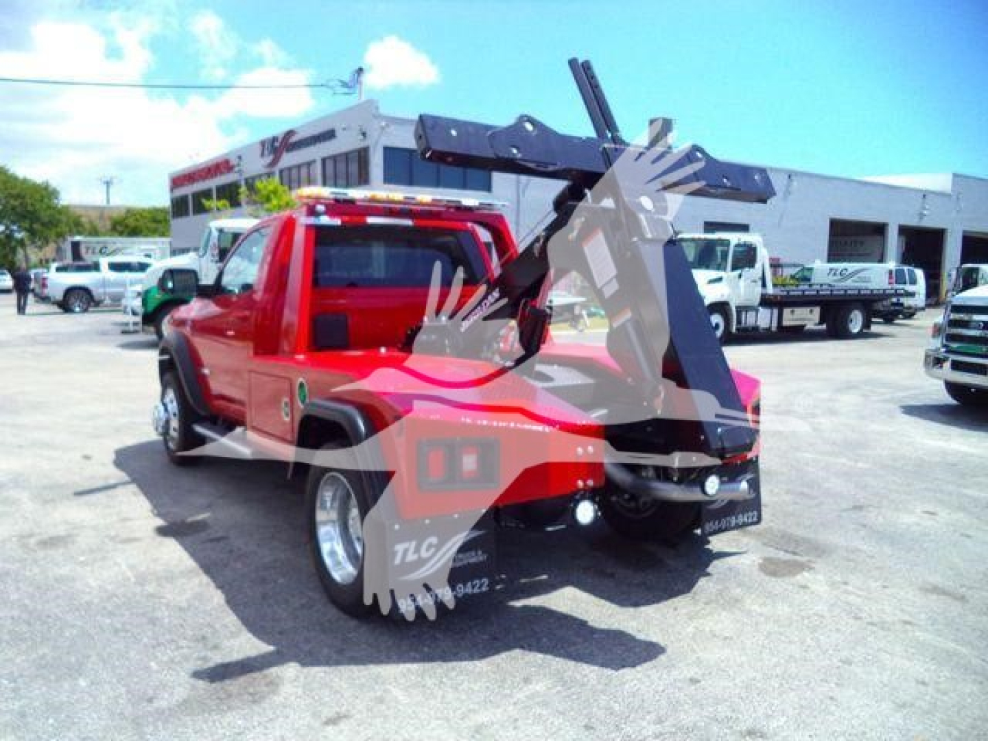 Ram pickup with winch equipment showing rear view and crane arm in red color.