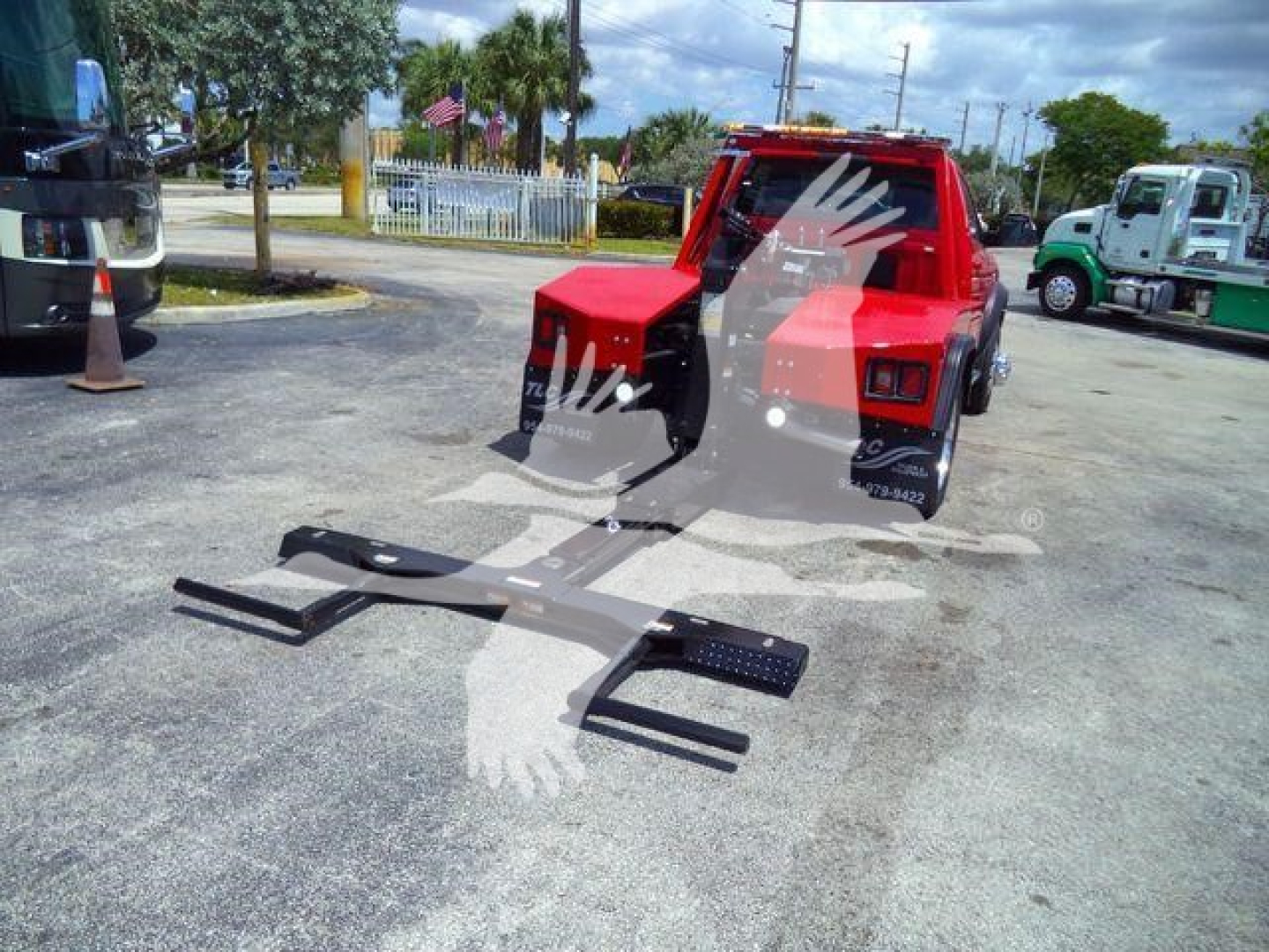 Ram 4500 SLT winch truck rear view showing winch frame and forks in an outdoor lot.