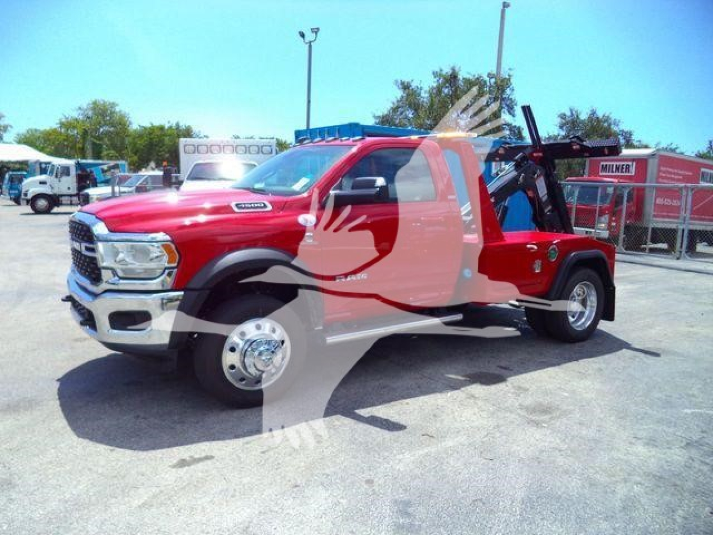 Ram 4500 truck in red with winch equipment on bed, side view showing front chrome grille and dual rear wheels.