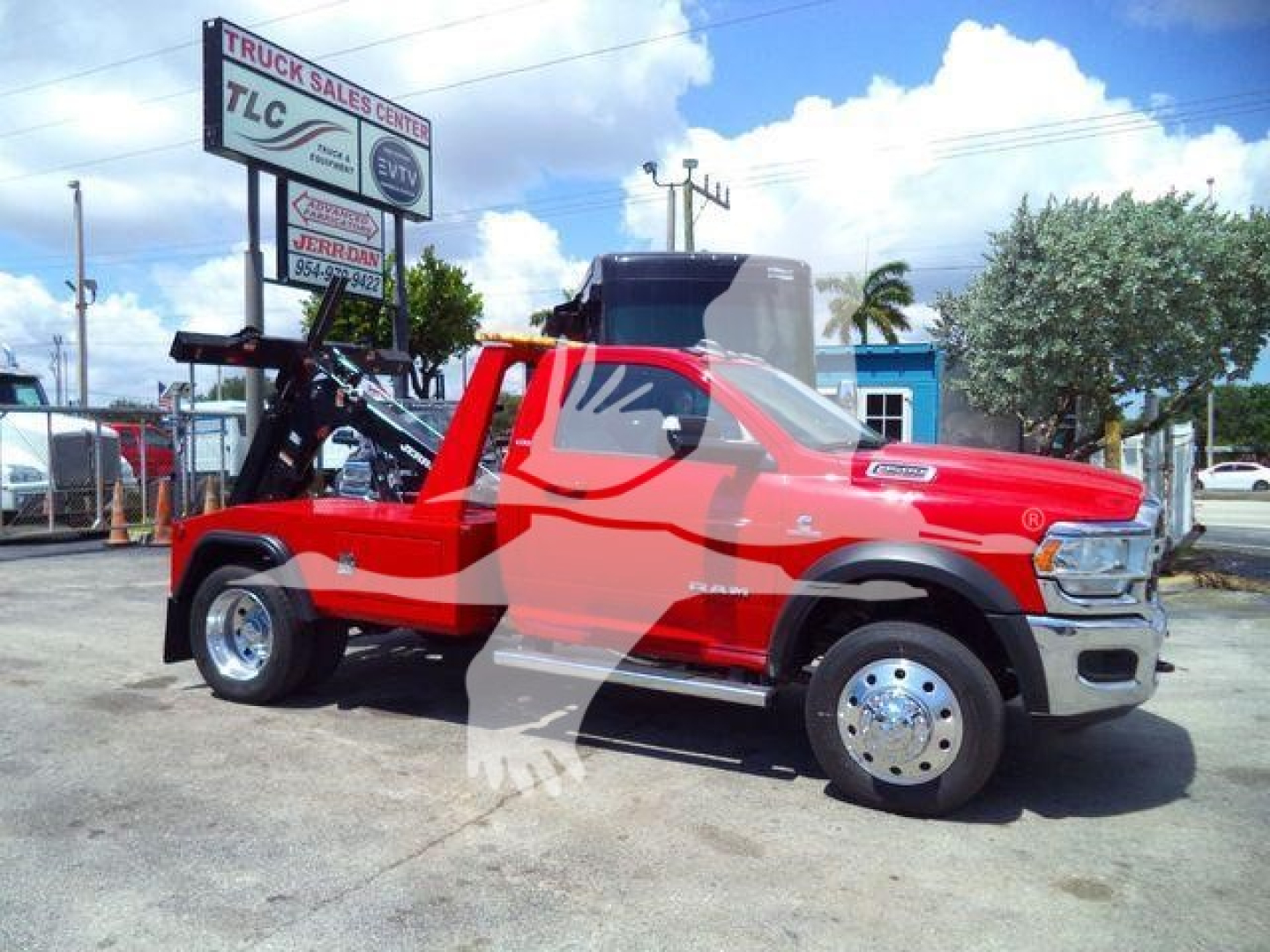Ram 4500 pickup in red cab with front chrome bumper and dual rear wheels, winch equipment mounted in bed, side view showing logo and dealership lot.