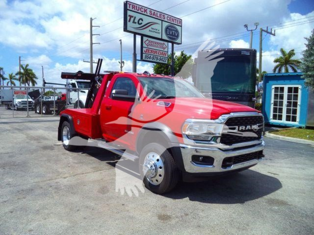 Ram 4500 SLT pickup truck in red with chrome grille and dual rear wheel hauler, front hood open, on dealer lot with signage in background.