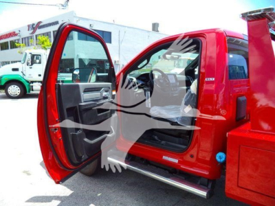 Ram 4500 truck cab interior showing driver door open, red exterior, black and gray interior, step rail visible