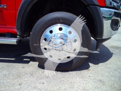 Ram 4500 front wheel assembly showing large chrome hubcap and tire, with fender and side step visible.
