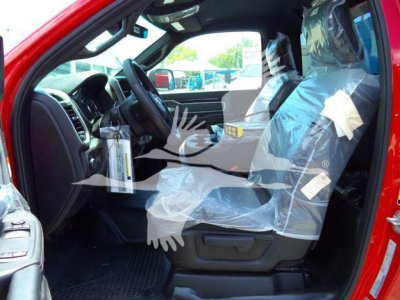 Ram 4500 interior view showing front driver seat wrapped in plastic and dashboard; red exterior visible on the door jamb.