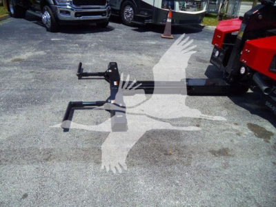 Truck equipment stand and hitch attachment on pavement with vehicles in background. No legible brand text visible.
