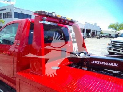 Red Ram 4500 truck with winch system and Jerr-Dan branding, side view showing hooks and rear setup.