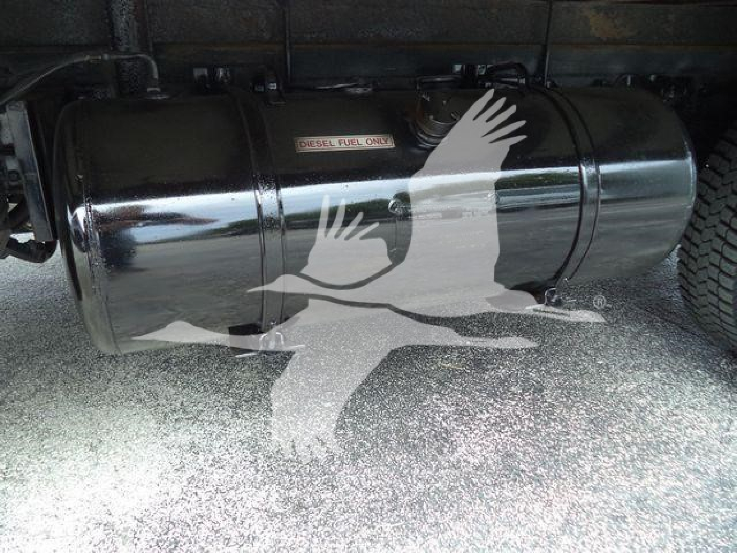 Fuel tank under truck showing Diesel fuel only label and chrome cylindrical tank