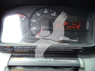 Dashboard of a refrigerated truck showing speedometer and digital readout with VIN and stock number on display.