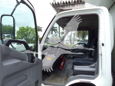 Medium shot of a 2020 Hino 195 refrigerated truck cab interior showing open door, steering wheel, driver seat, dashboard, and a red fire extinguisher mounted under the dash.