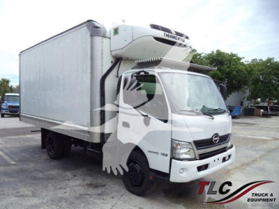 Medium-duty white refrigerated truck with a front cab and a large cargo box; Thermo King unit on top of cab; no visible license plate.