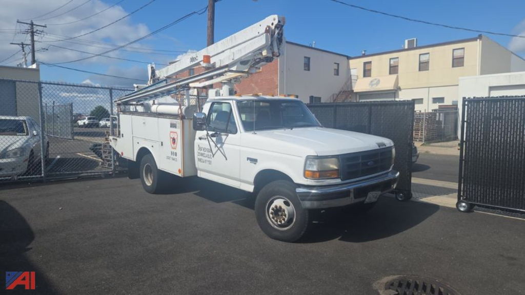 Bucket truck: white Ford F-450 service bucket truck with elevated boom in service position