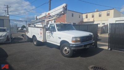 Bucket truck: white Ford F-450 service bucket truck with elevated boom in service position