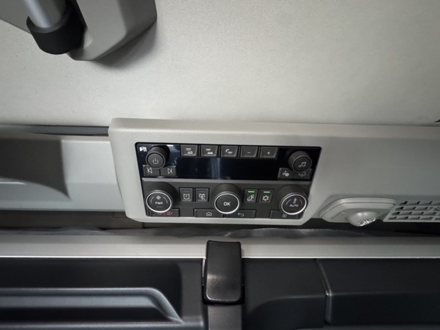 Volvo VNL sleeper cab interior control panel view showing dashboard buttons and climate/infotainment controls.