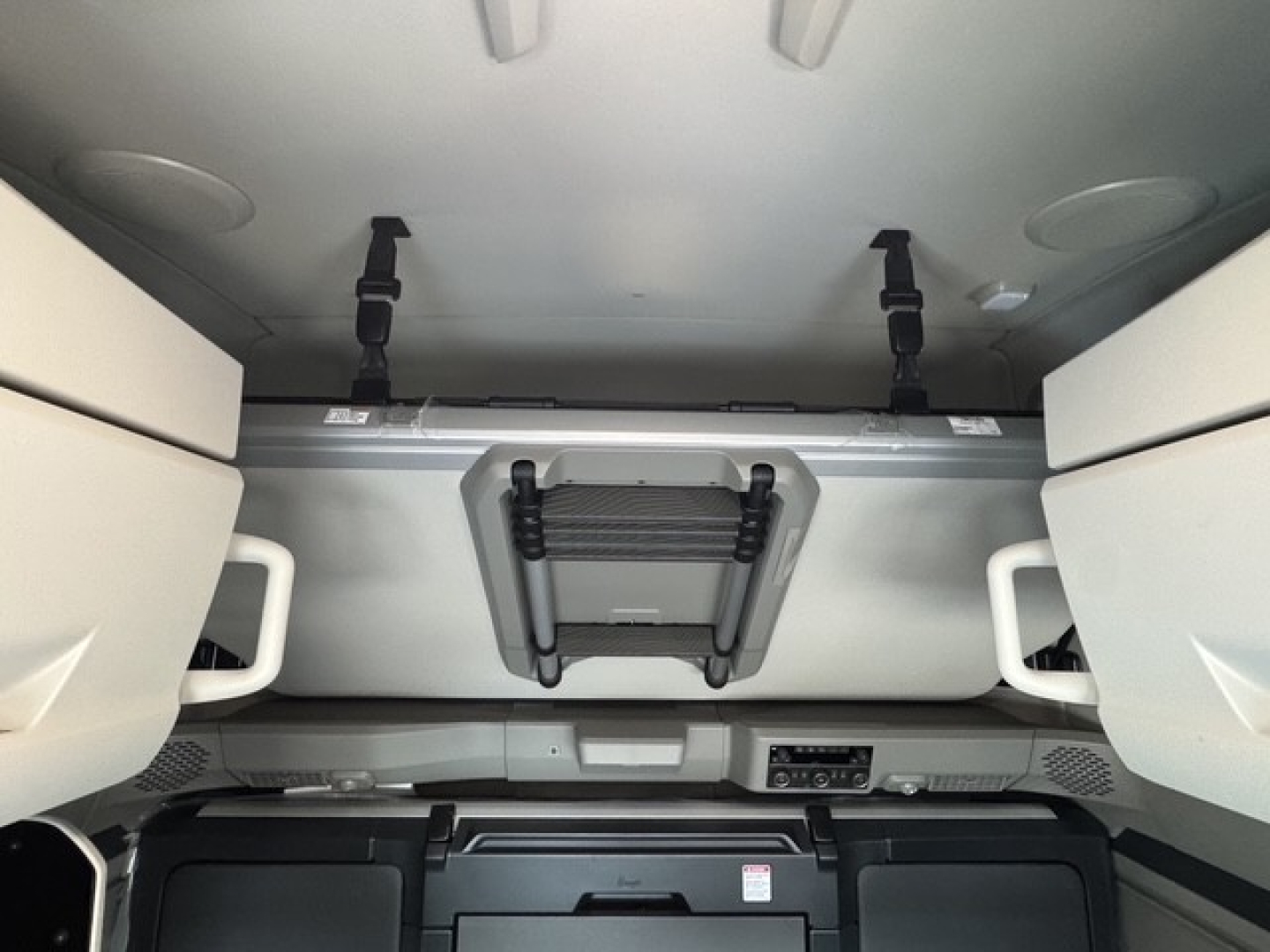 Volvo VNL64T860 cab interior with overhead storage and latches, view from sleeper area showing ceiling panels and storage compartments