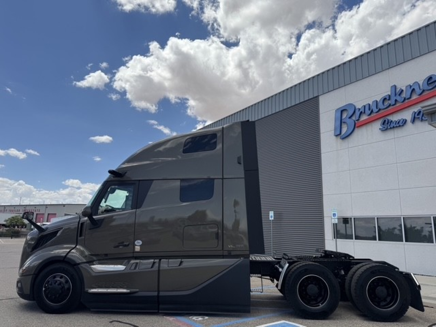 Volvo VNL64T860 tractor unit side view showing sleeper cab and chassis, with a stacked sleeper fairing and dual rear axles.