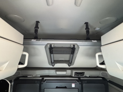 Volvo VNL64T860 cab interior with overhead storage and latches, view from sleeper area showing ceiling panels and storage compartments