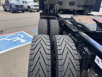 Volvo VNL64T860 chassis showing dual rear axles and tire tread detail with accessible wheel wells.