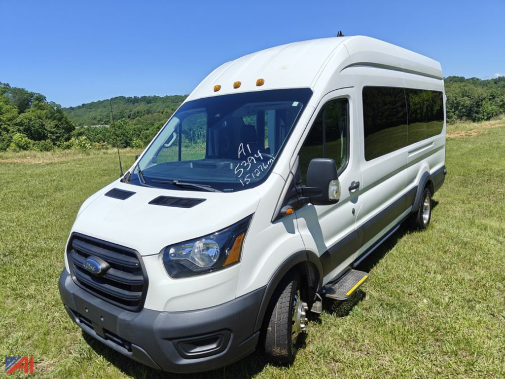 Ford Transit van with wheelchair lift, side view, white cargo/passenger van, raised wheelchair ramp visible