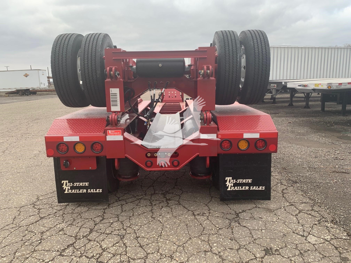 Trailer rear view showing red Fontaine lowboy with twin rear axles and dual mud flaps reading TRI-STATE TRAILER SALES.