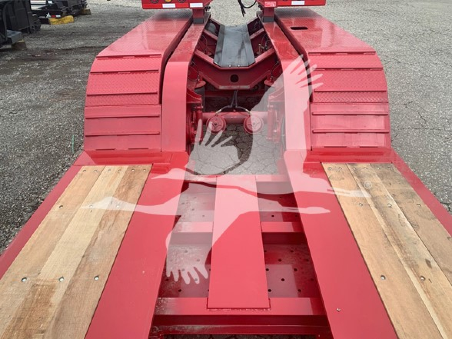 Trailer frame of a Fontaine lowboy 55Lcc showing red structural members and wooden deck planks.
