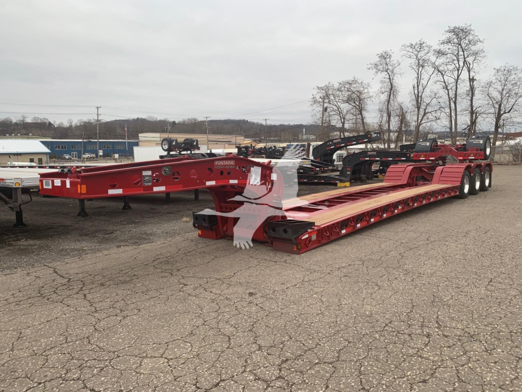 Fontaine 55Lcc lowboy trailer showing red frame and gooseneck base with multiple axles and long deck.