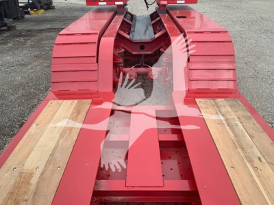 Trailer frame of a Fontaine lowboy 55Lcc showing red structural members and wooden deck planks.