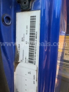 Truck door jamb showing a white barcoded label with VIN and stock details. Text includes MADE IN THE UNITED STATES OF AMERICA, 2008/201? dates, and UPC-style barcode.