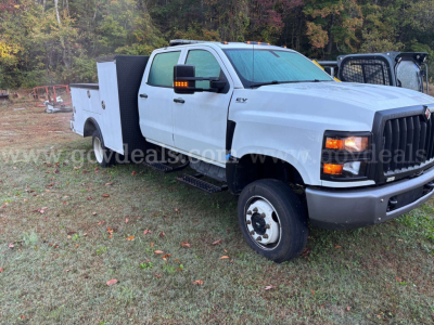 Service/utility truck cab front-right view showing 2020 International CV515, utility bed with compartments, VIN 1HTKTSWM4LH368969 visible on tag