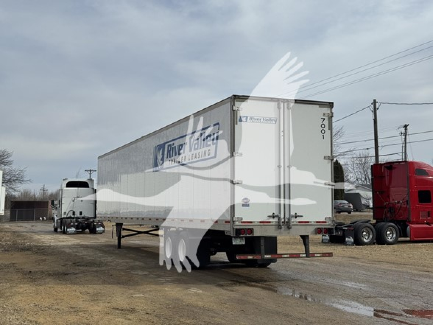 Trailer side and rear showing River Valley trailer leasing logo on white dry van trailer.