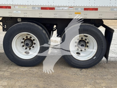 Dual rear wheels of a 2017 Utility dry van trailer showing tires and wheel rims with mud flaps.