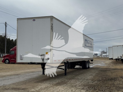 Used 2017 utility dry van trailer with white box, front hitch and landing gear, stock number 7001-2, VIN visible on side.