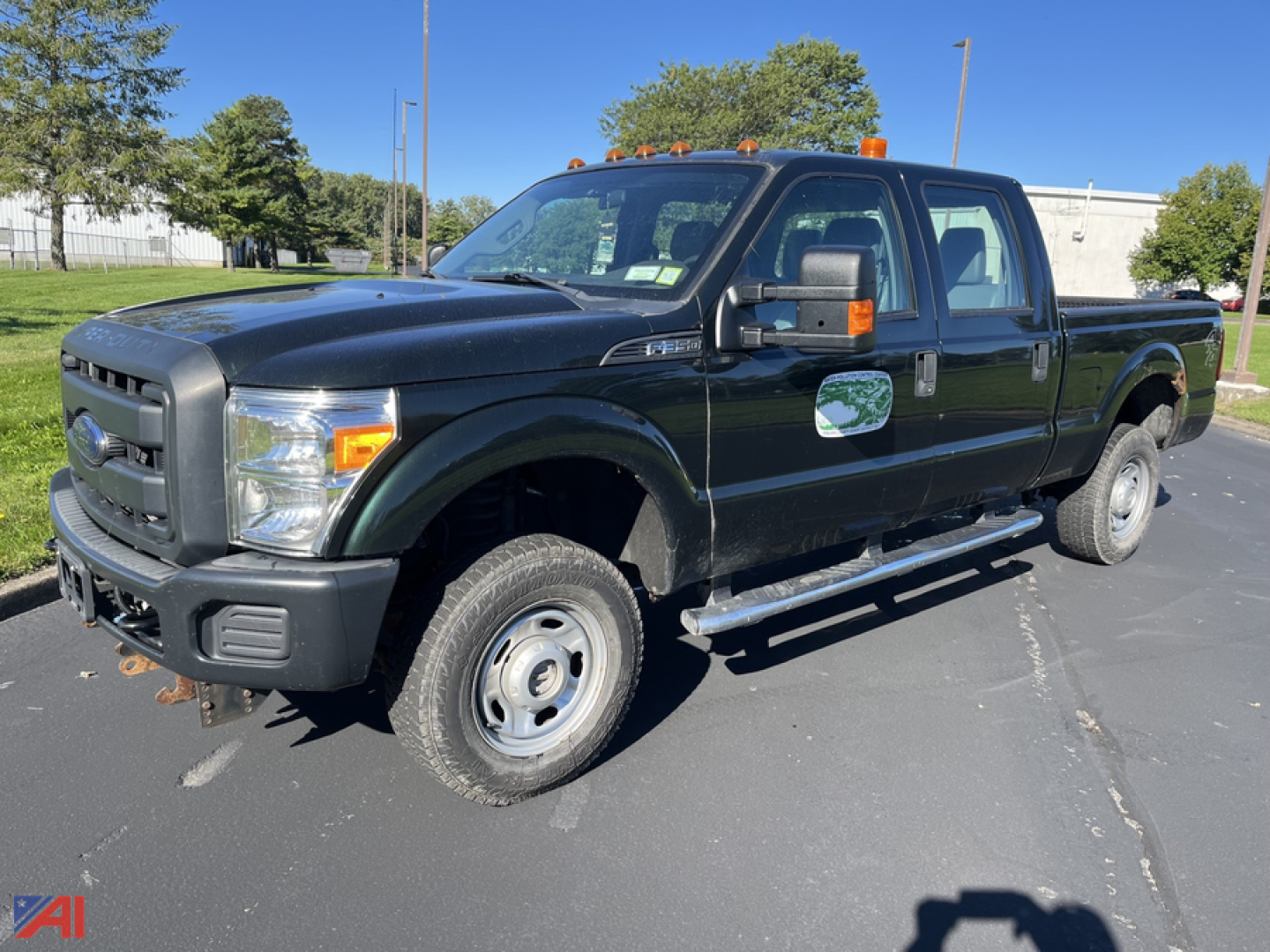 Ford F-350 Super Duty pickup truck in black, extended cab, dual rear wheels, with orange cab lights and side steps.