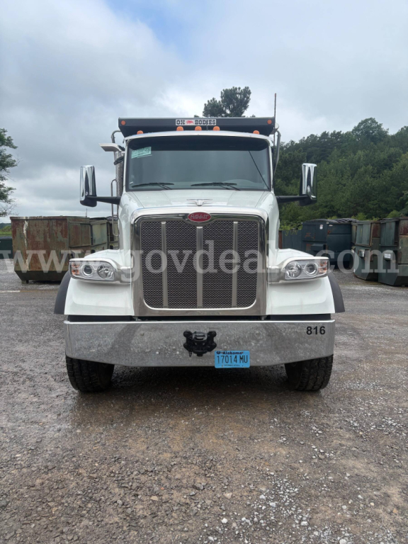 Peterbilt 377 dump truck front view showing chrome grille, large headlights, blue license plate, and stock number 27512-68