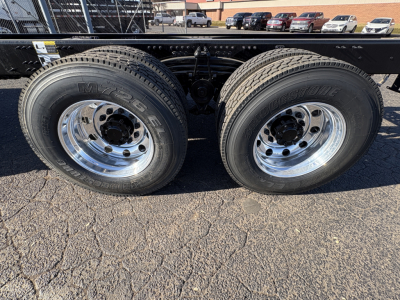 Dual rear wheels showing MXS brand tires and polished chrome rims on a Mack GR64B chassis side view.