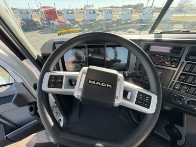 Dashboard and steering wheel view of a 2027 Mack GR64B truck cab with Mack logo on the steering wheel and instrument cluster visible.
