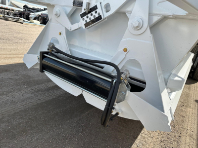 Ranco bottom dump trailer hitch area showing hydraulic hoses and metal frame components.