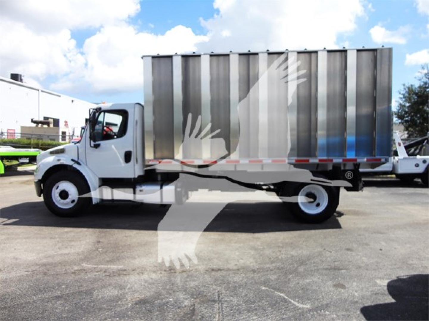 Freightliner M2 106 dump truck side view showing cargo bed and chassis