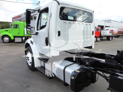 Freightliner M2 106 truck cab and chassis in view showing side of cab and fuel tank with chassis components.
